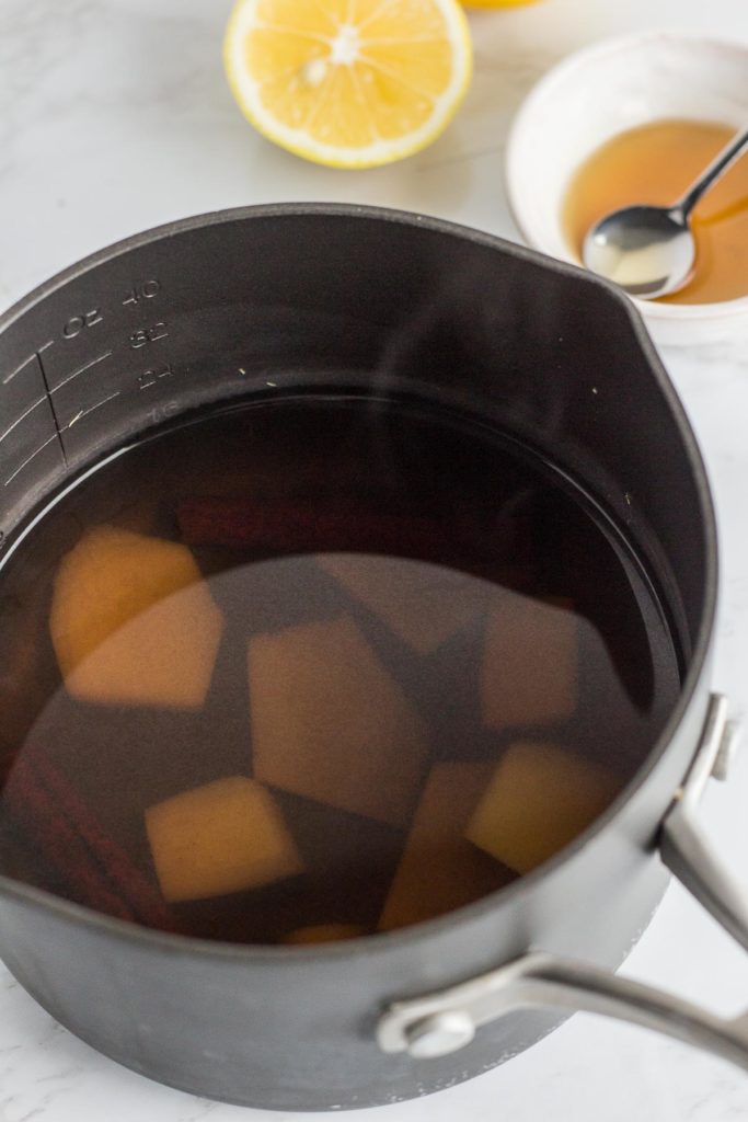 water boiled with ginger slices and cinnamon stick in the pot
