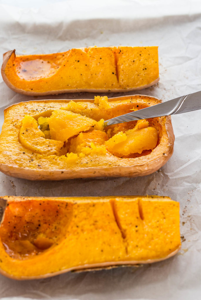 After taking the roasted butternut squash out of the oven. In process of scooping the meat out with the spoon.