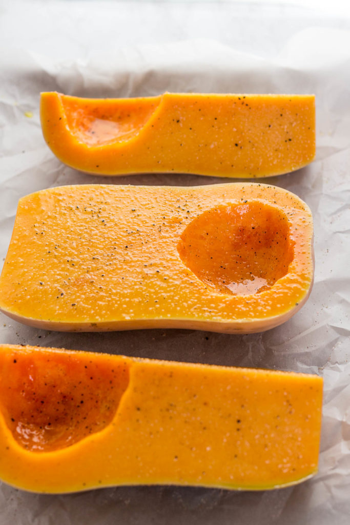 Butternut squash before roasting in the oven, seasoned with salt and pepper