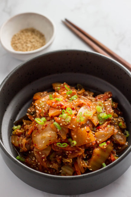 stir fried kimchi in a black bowl