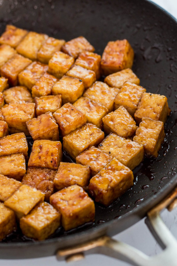 close up photo of vegan teriyaki pan-fried tofu in the pan