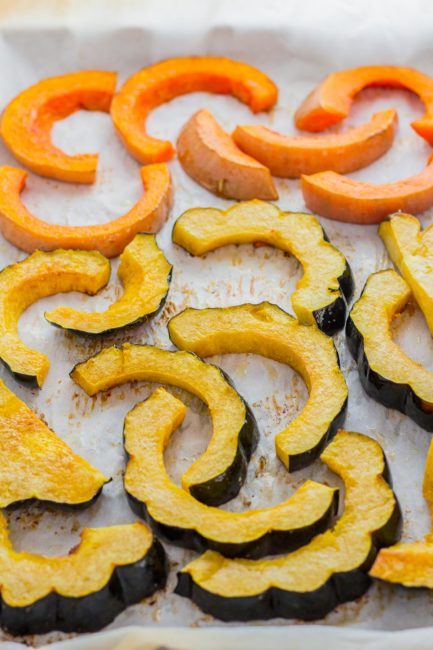 Roasted acorn squash and butternut squash on a baking pan