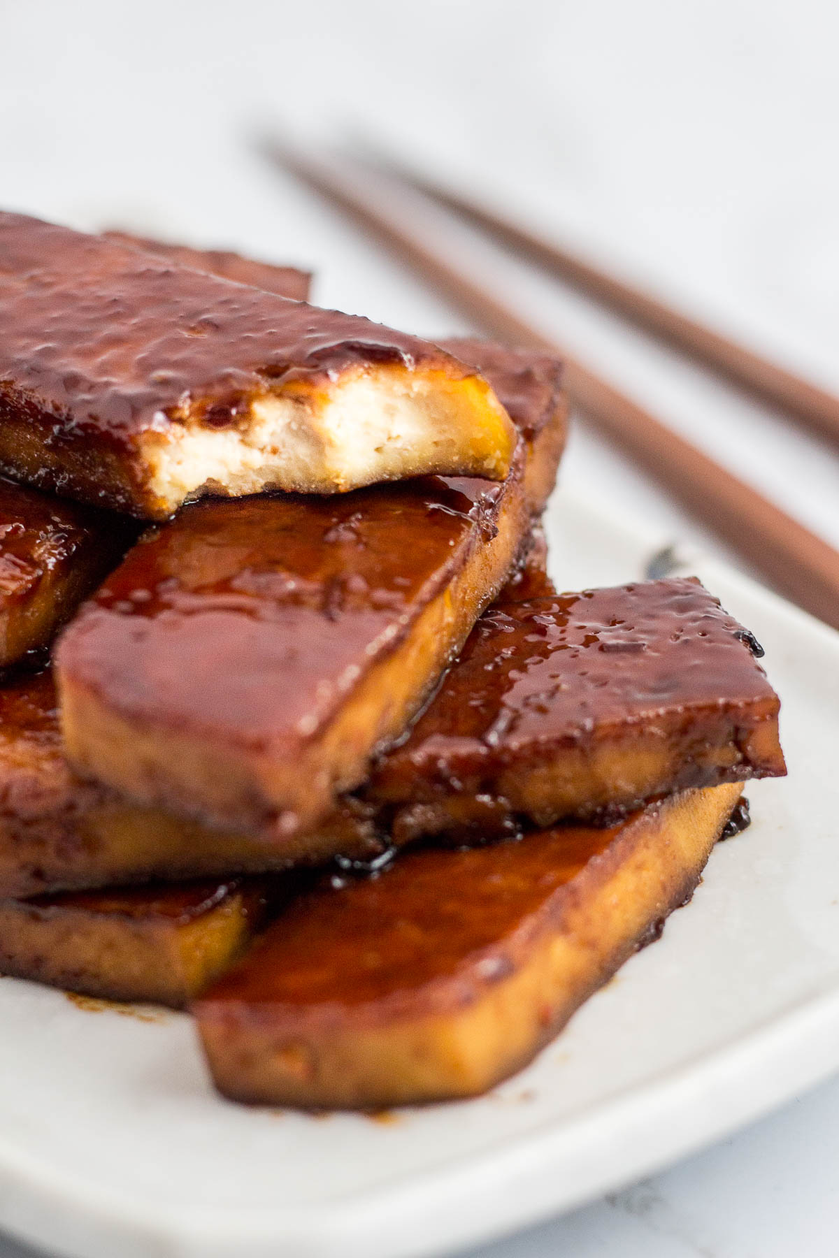 Closed up shot of oven baked hoisin tofu with a bite taken off