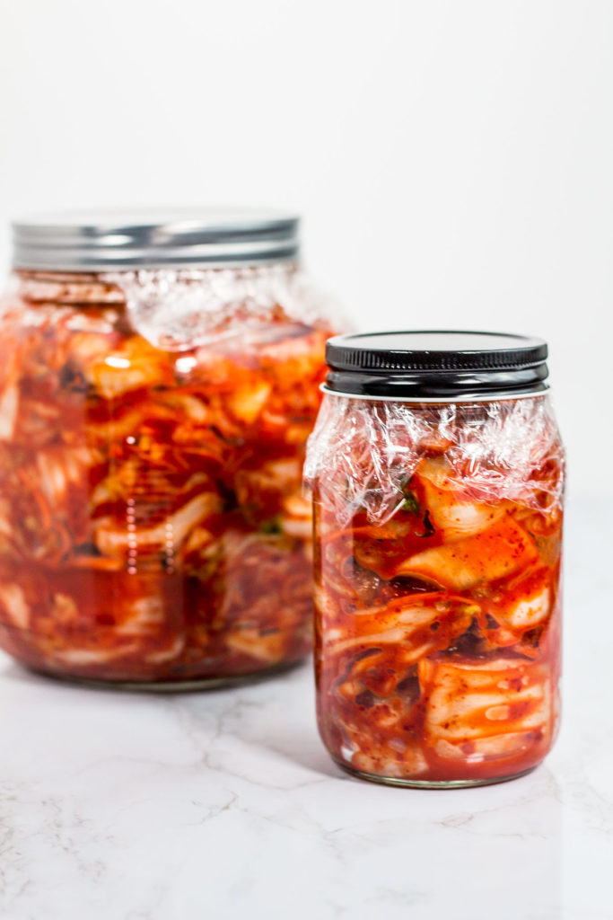 Glass jars of prepared homemade vegan kimchi, ready to be fermented