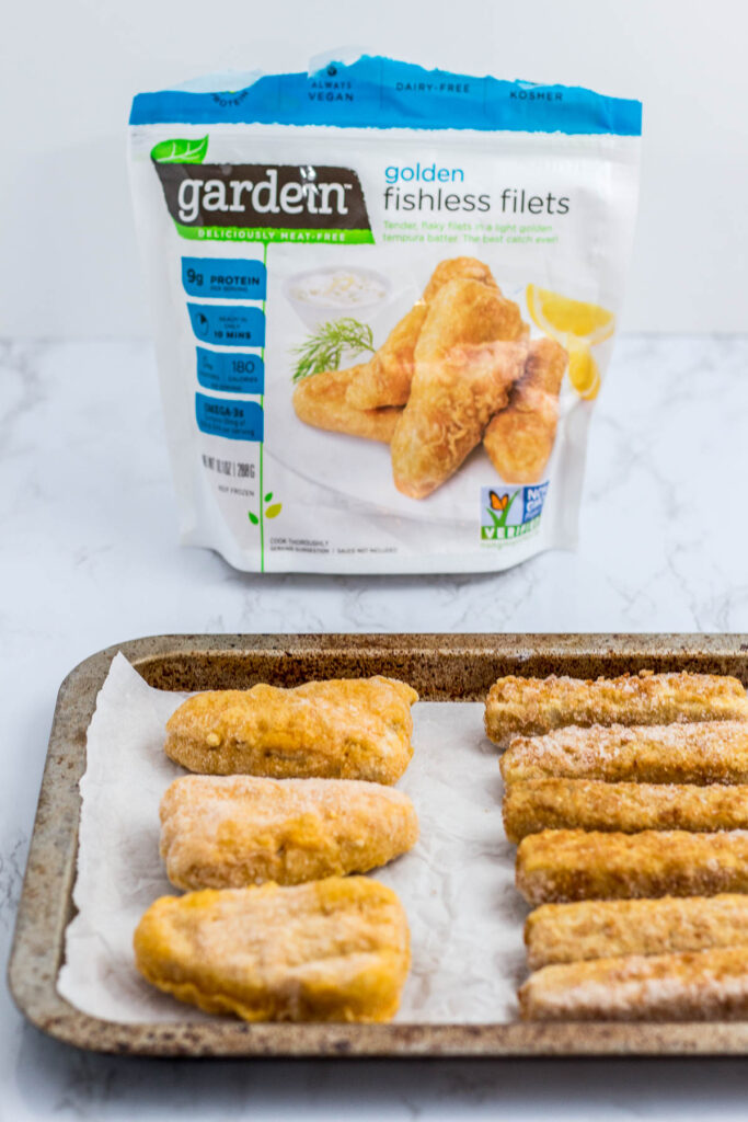 a picture of both frozen fish sticks and fishless filets before baking in the oven