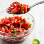 A spoonful of fresh homemade tomato salsa with red wine vinegar