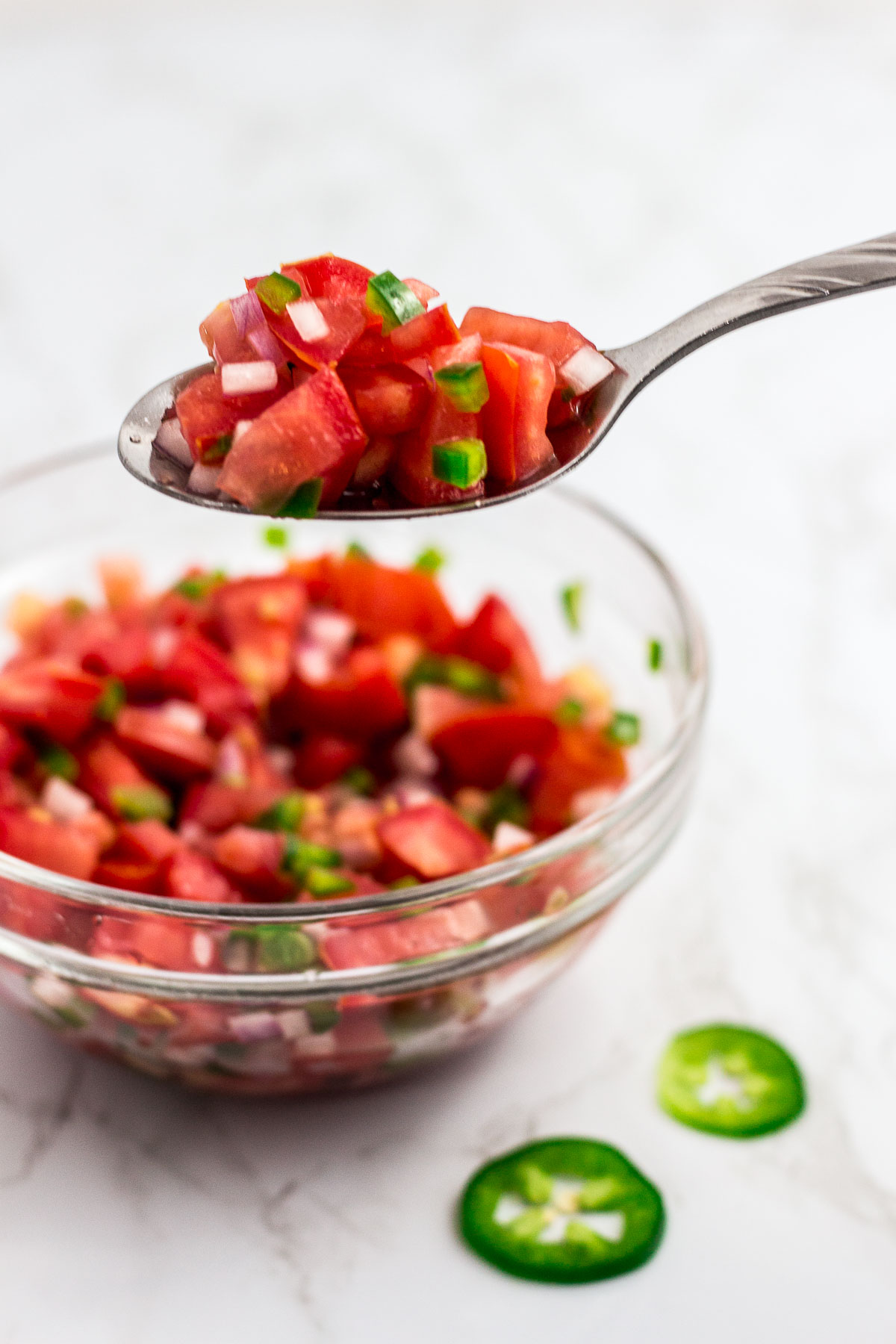 A spoonful of fresh homemade tomato salsa with red wine vinegar