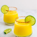 two frozen margarita with lime garnish