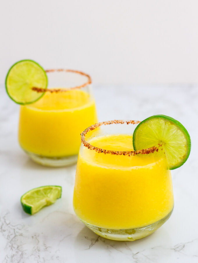 two frozen margarita with lime garnish