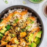 overhead shot of vegan sushi bowl with rice, vegan fish filets, avocado, cucumber