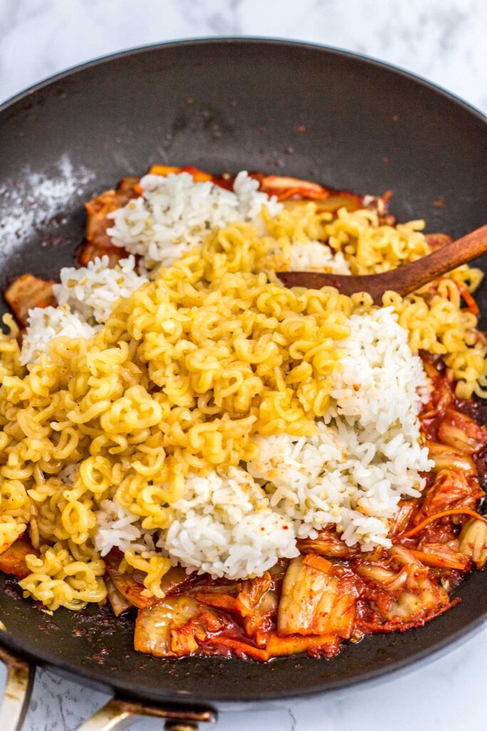 In the process of making the fried rice - once the rice and ramen is dumped on top of fried kimchi