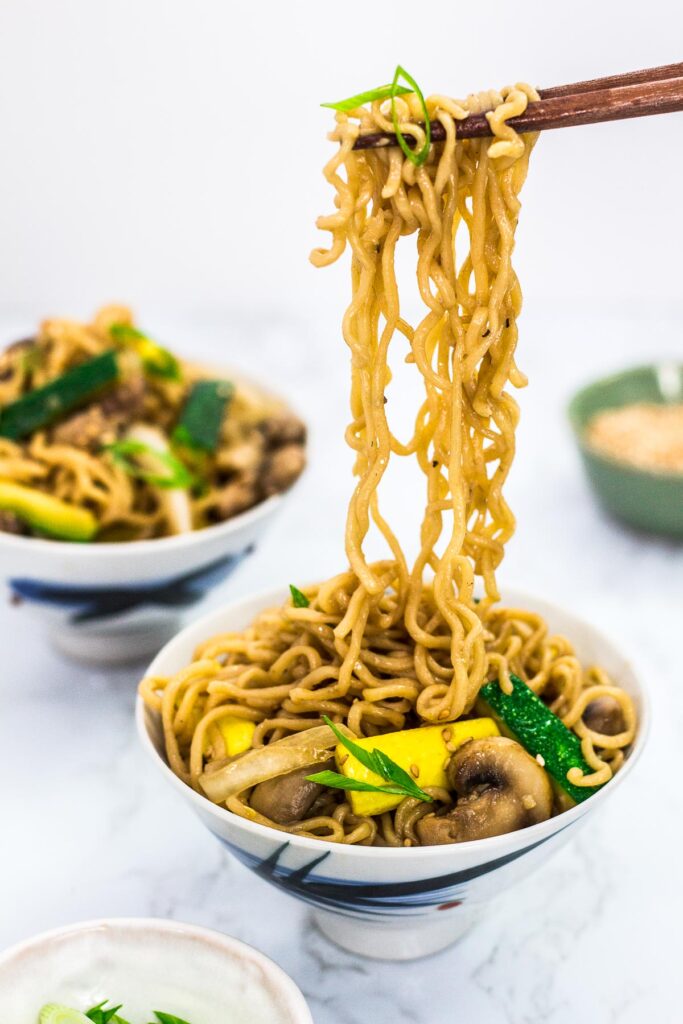 holding stir fried ramen with chopsticks