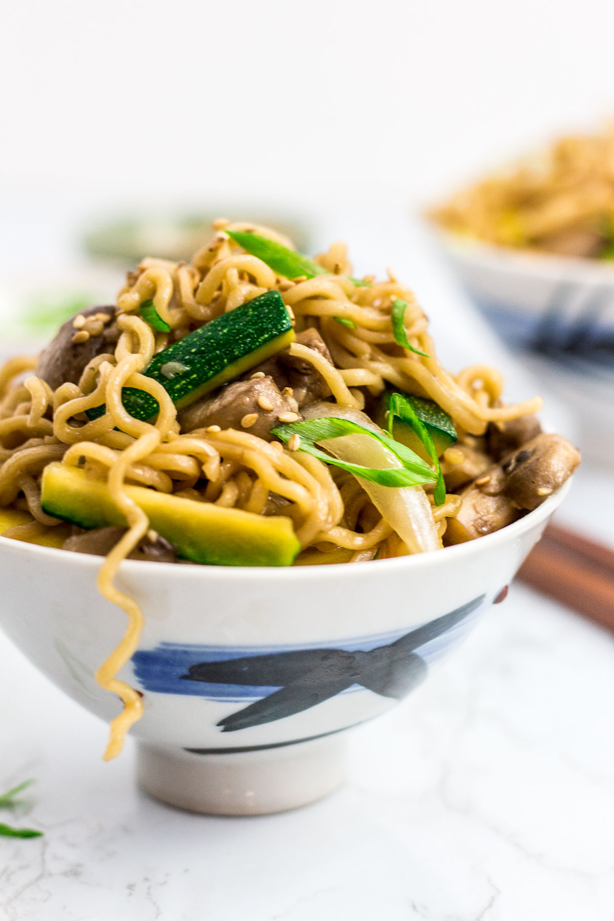 a white bowl filled with hibachi vegetable stir fried ramen