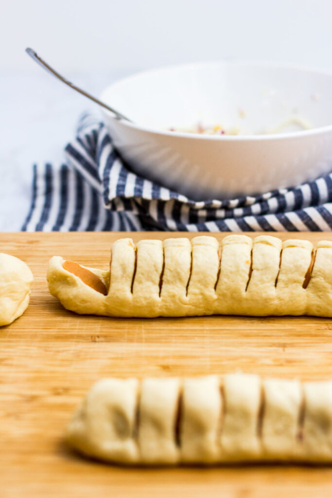 cut the hot dog wrapped in crescent dough