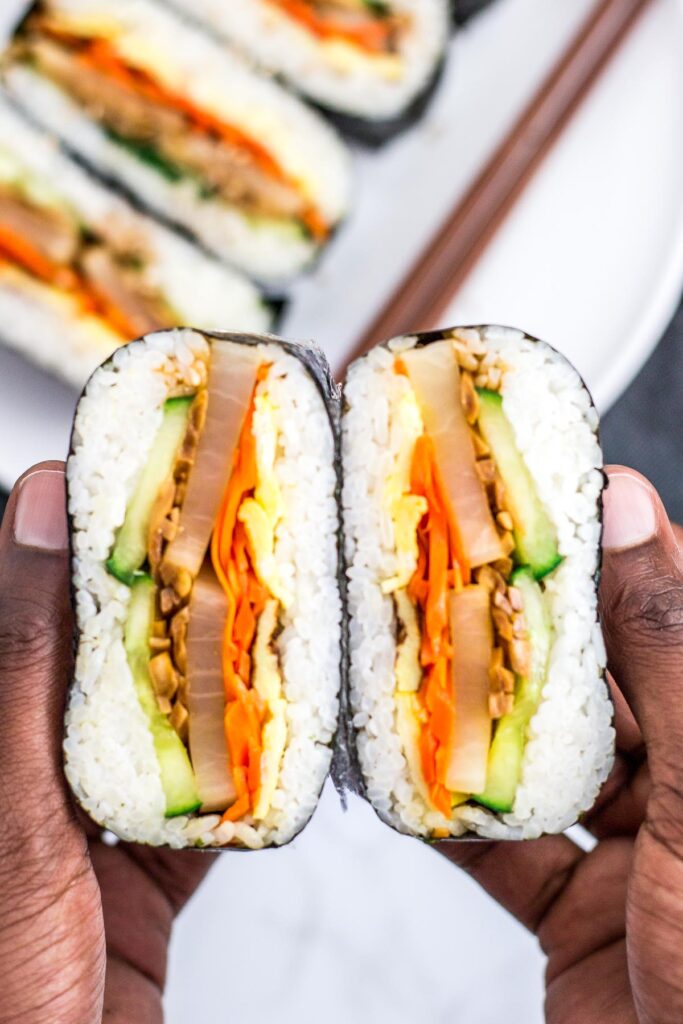 vegetarian kimbap onigirazu cut in half to show the fillings