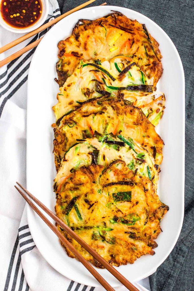 5 cooked Korean savory scallion pancakes on a white plate