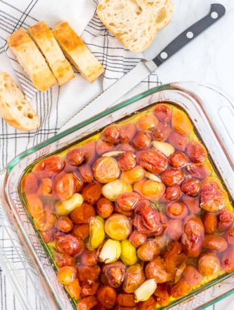 overhead shot of slow cherry tomatoes in olive oil in the oven