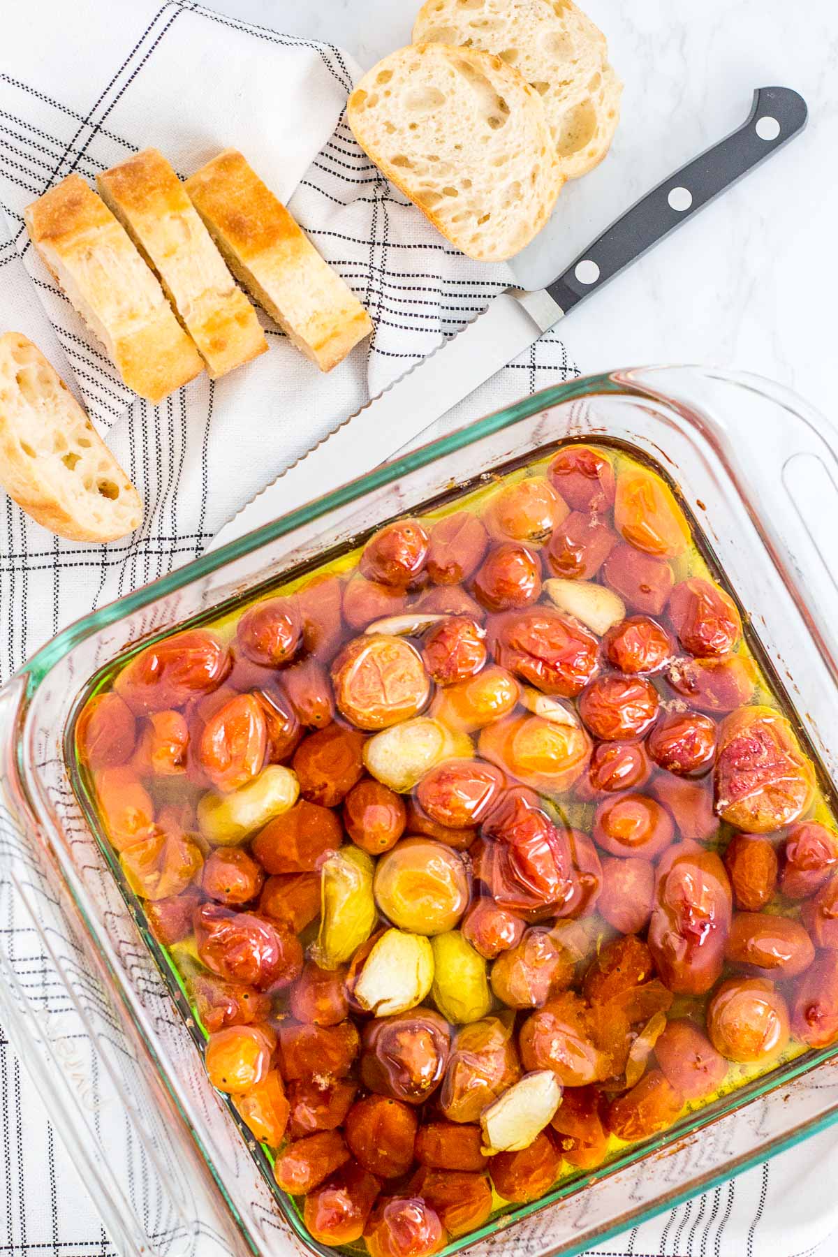 overhead shot of slow cherry tomatoes in olive oil in the oven