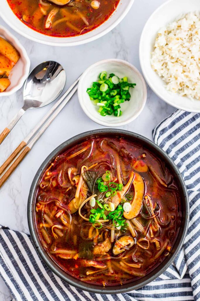 vegan version of mushroom yukgaejang with rice and kimchi on the side