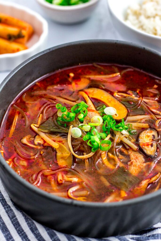 Big bowl of vegan mushroom yukgaejang with green onion garnish on top