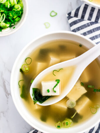 vegan miso soup with green onion garnish