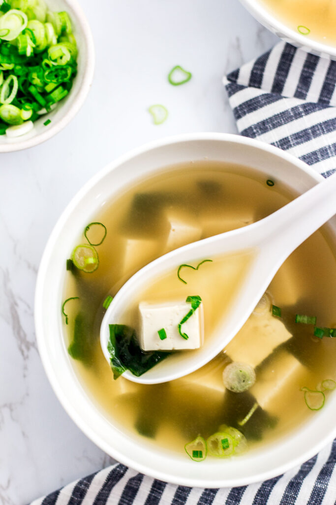 vegan miso soup with green onion garnish