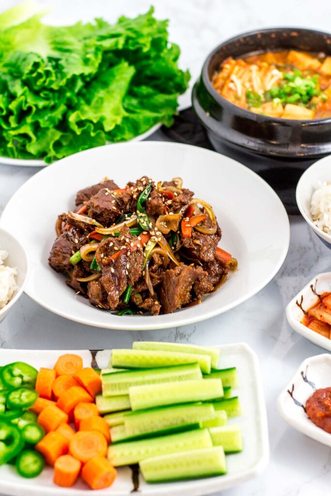 lettuce, seitan bulgogi, Korean bean paste soup, and other Korean BBQ side dishes