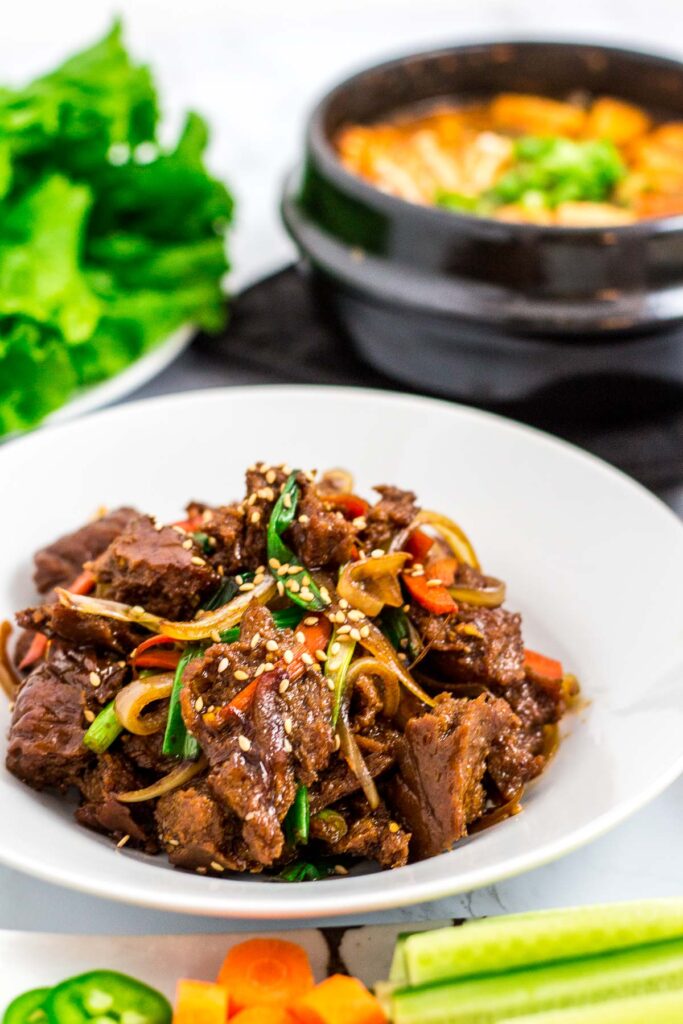 seitan bulgogi, vegan Korean bean paste soup and lettuce in the background