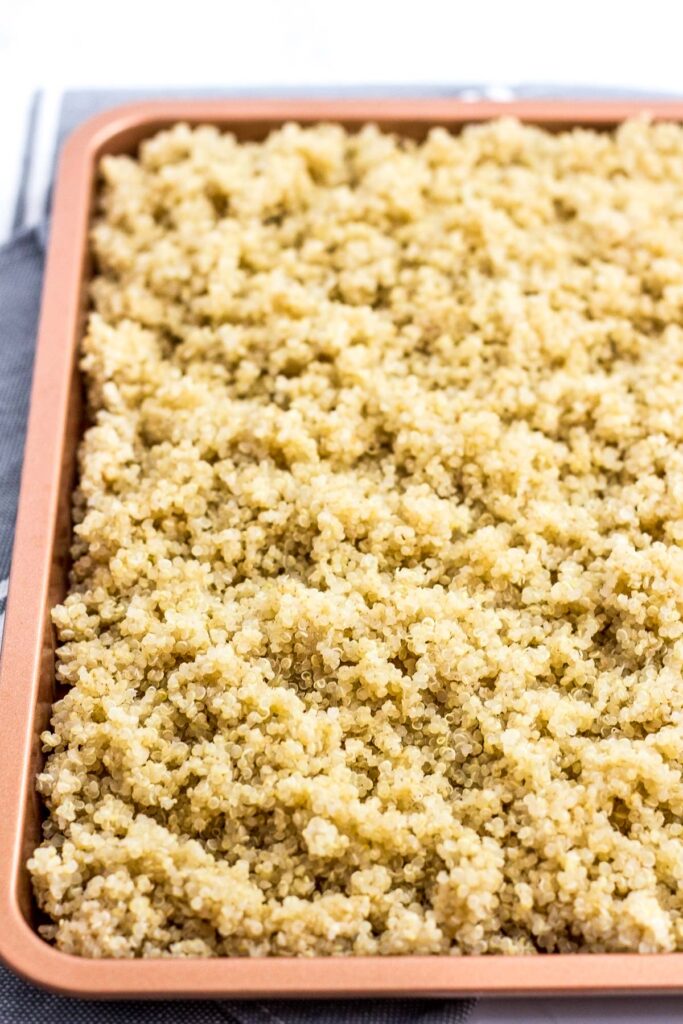 Cooling cooked quinoa in the baking sheet