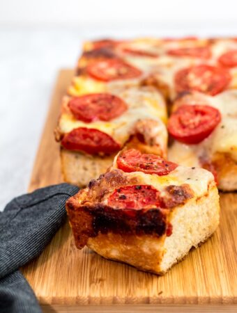 Close up shot of a piece of Detroit style pizza