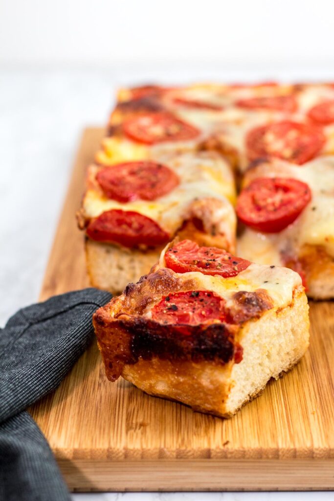 Close up shot of a piece of vegetarian Detroit style pizza