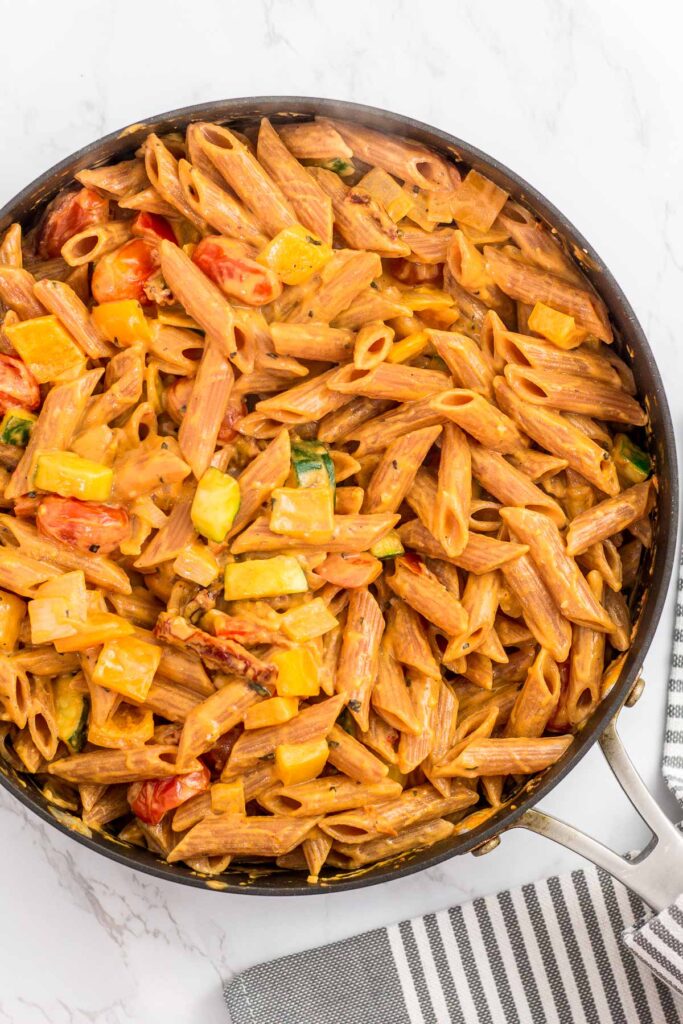 Overhead shot of creamy pasta primavera in the skillet