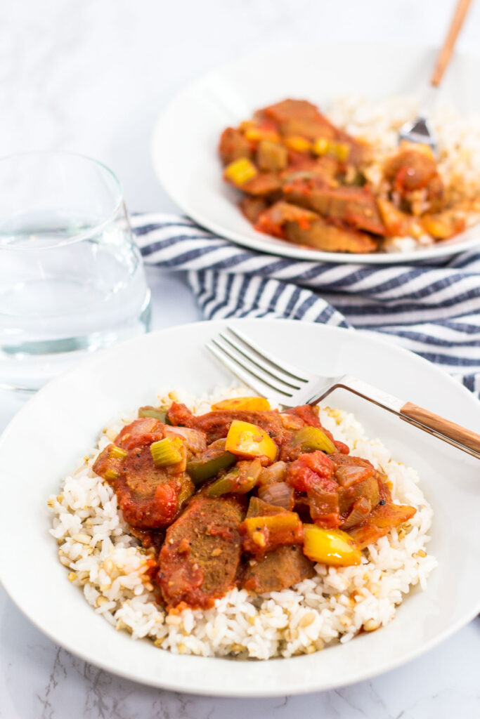 two bowls of vegan creole sausage cacciatore over rice