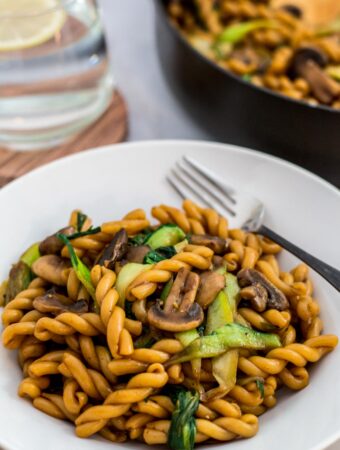 Close up photo of bok choy mushroom pasta stir fry