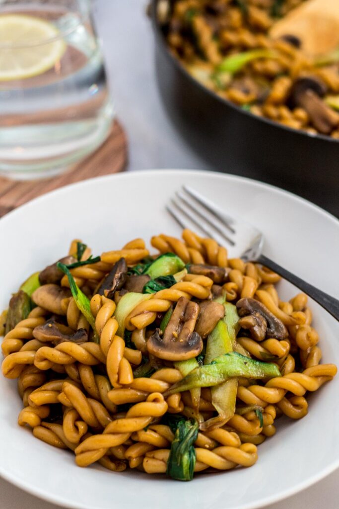 Close up photo of bok choy mushroom pasta stir fry