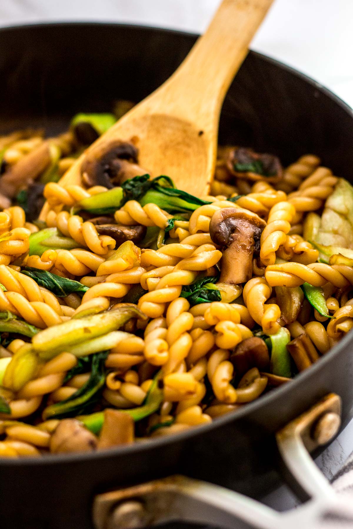 Close up photo of bok choy mushroom pasta stir fry