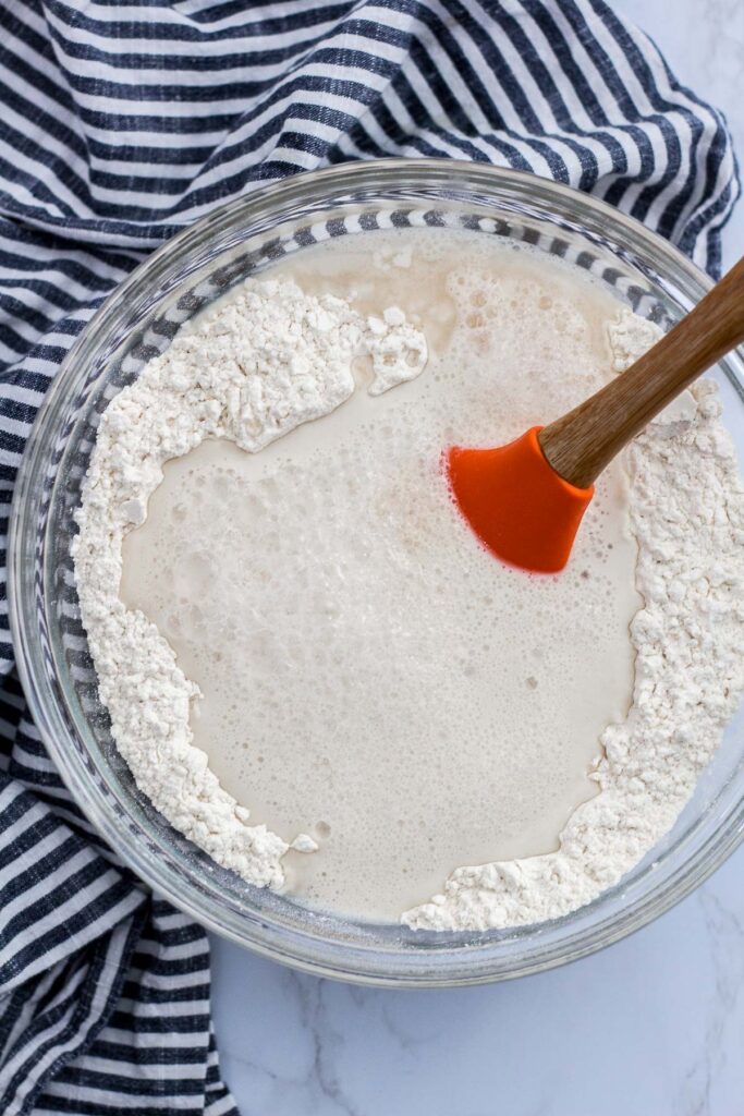 bloomed active dry yeast mixture poured into flour