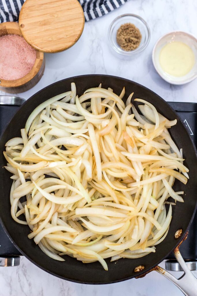 sliced onion being cook in a pan without any oil