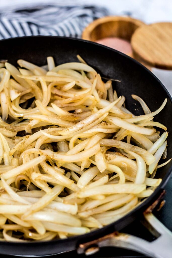 cooked sliced onion with brown sugar sprinkled on top