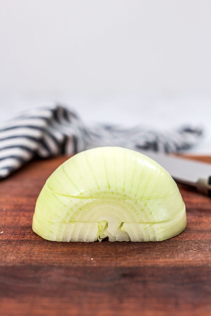 direct shot of half an onion cut parallel to the cutting board