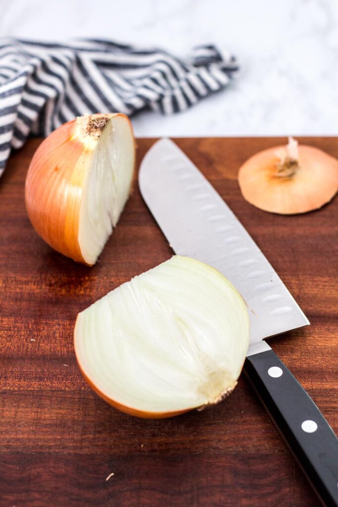 cut the onion in half on a cutting board with a knife
