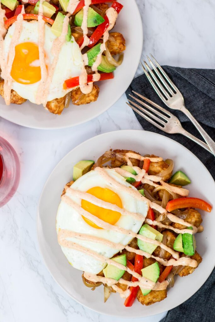 overhead shot of two plates of breakfast totchos