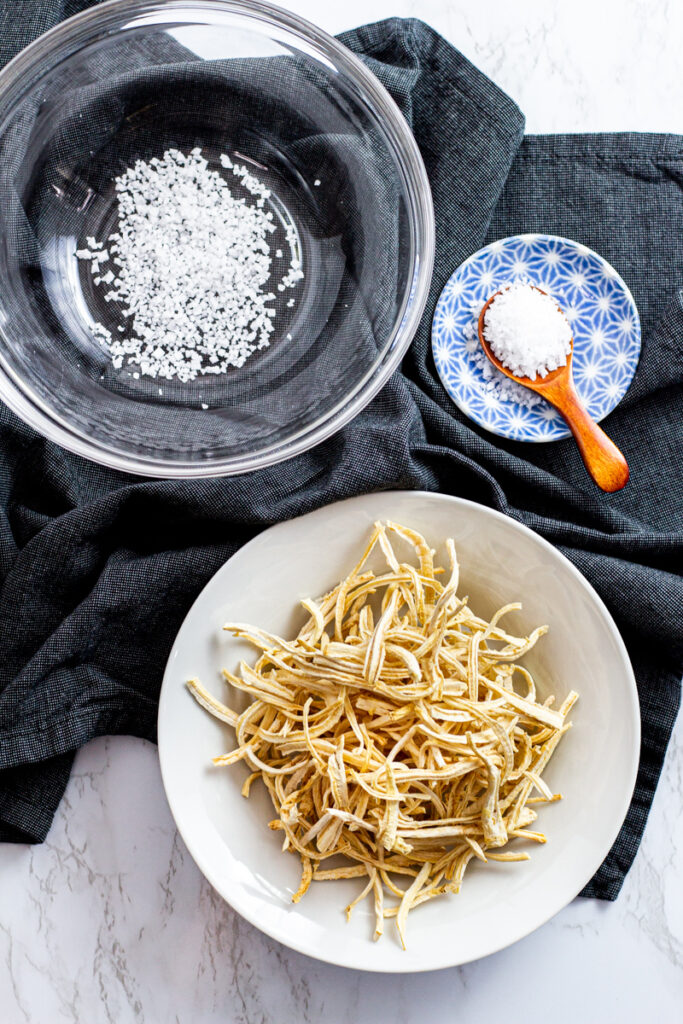 Korean coarse sea salt in a large bowl and dried bellflower roots