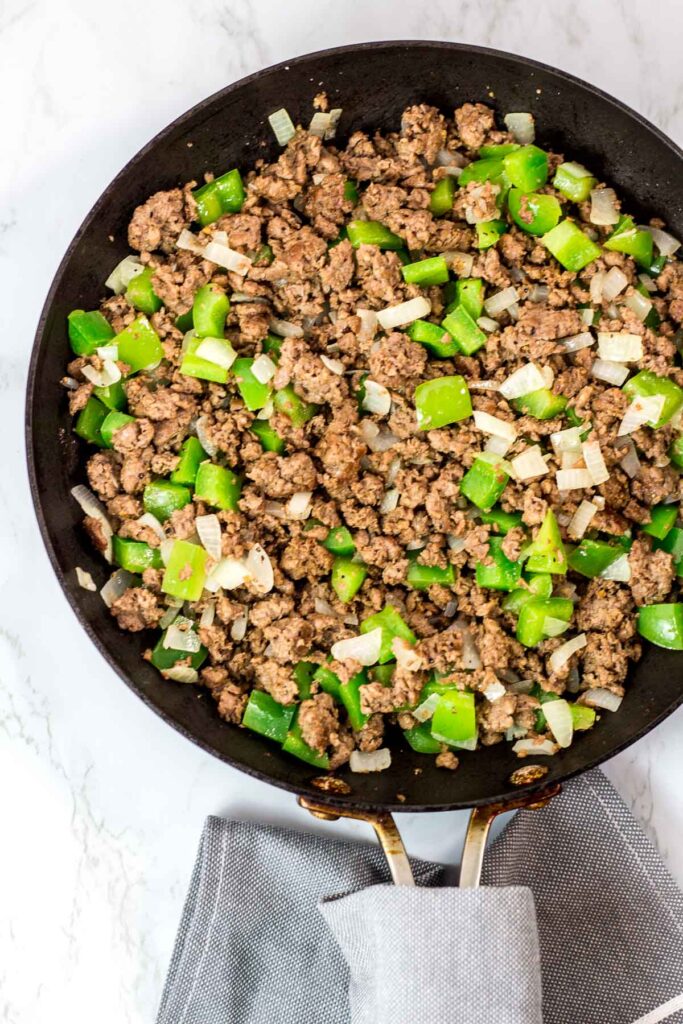 seasoned impossible meat, onion, and pepper seasoned for Philly cheesesteak sloppy joes