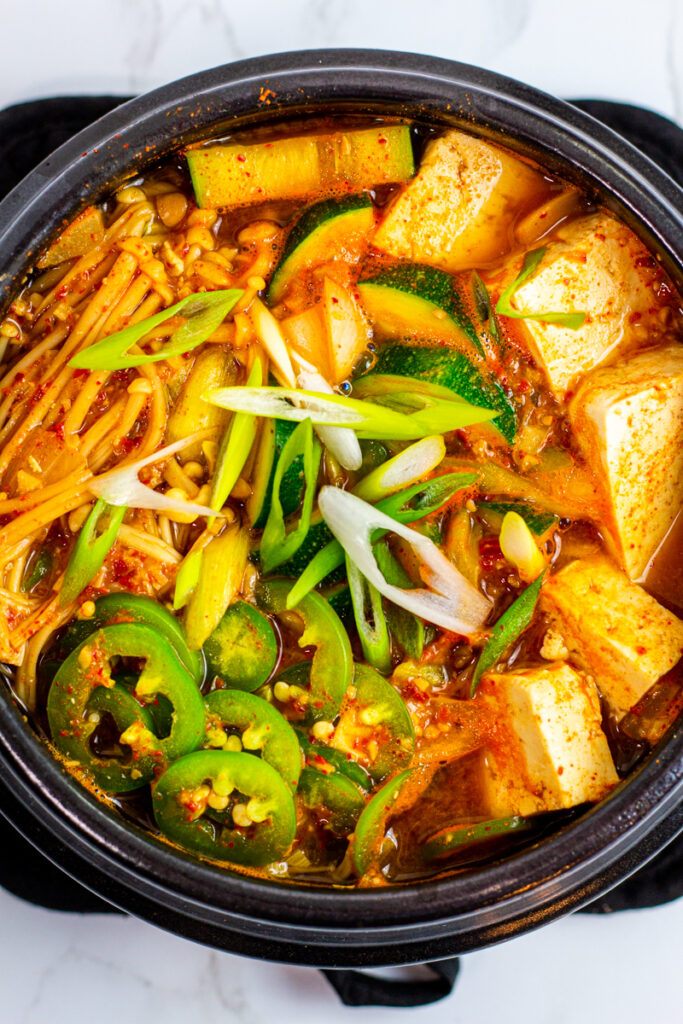 Korean soybean paste stew in a black clay pot.