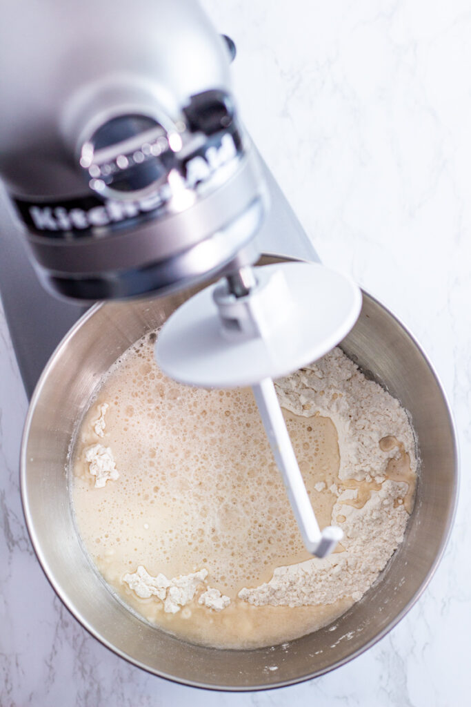 yeast mixture added to the flour in the stand mixer bowl.