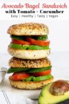 two stacked avocado bagel sandwiches.