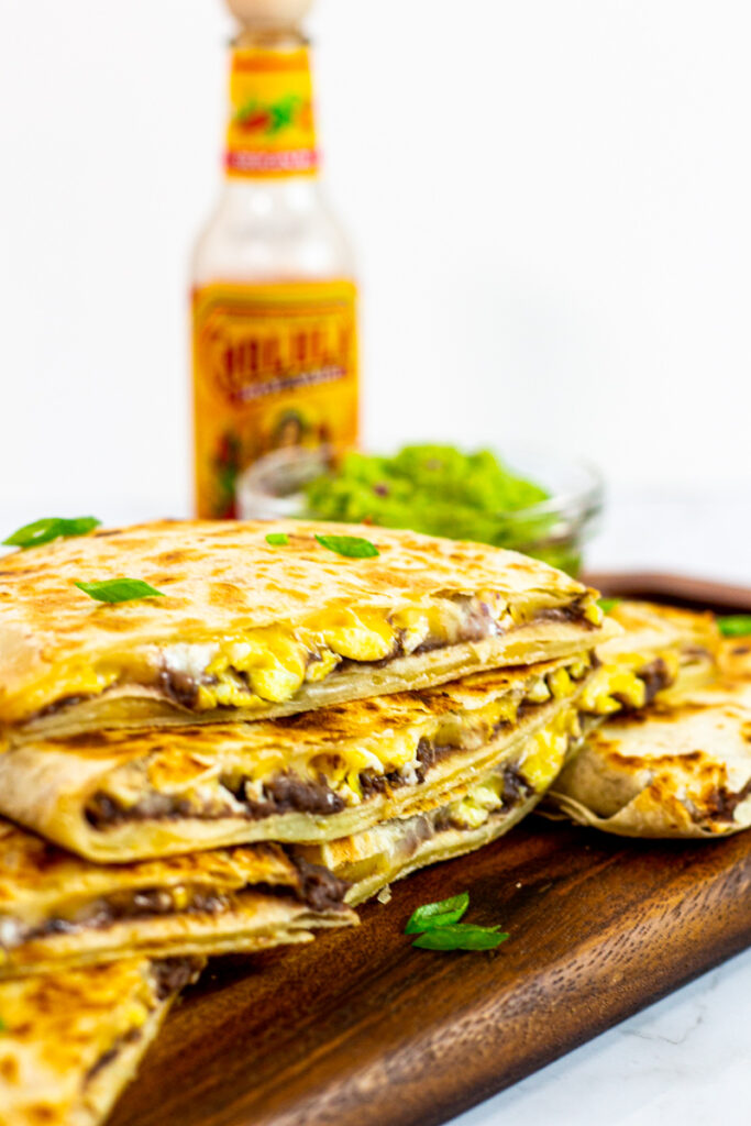 cut breakfast quesadillas with refried beans and eggs.