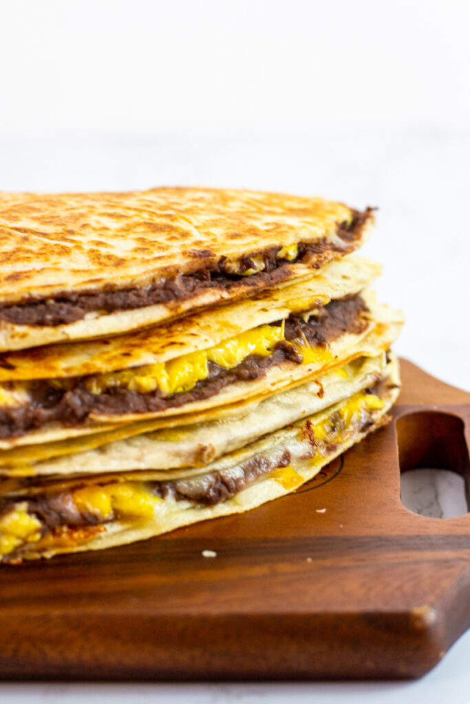 breakfast quesadillas on a wooden board.