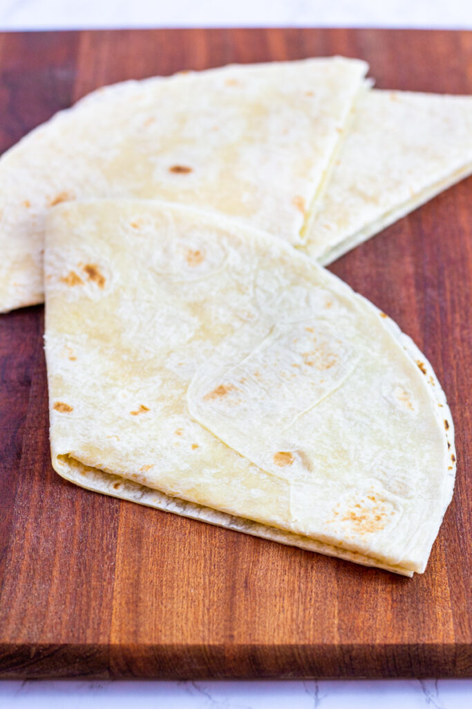 folding a large flour tortilla in 3.